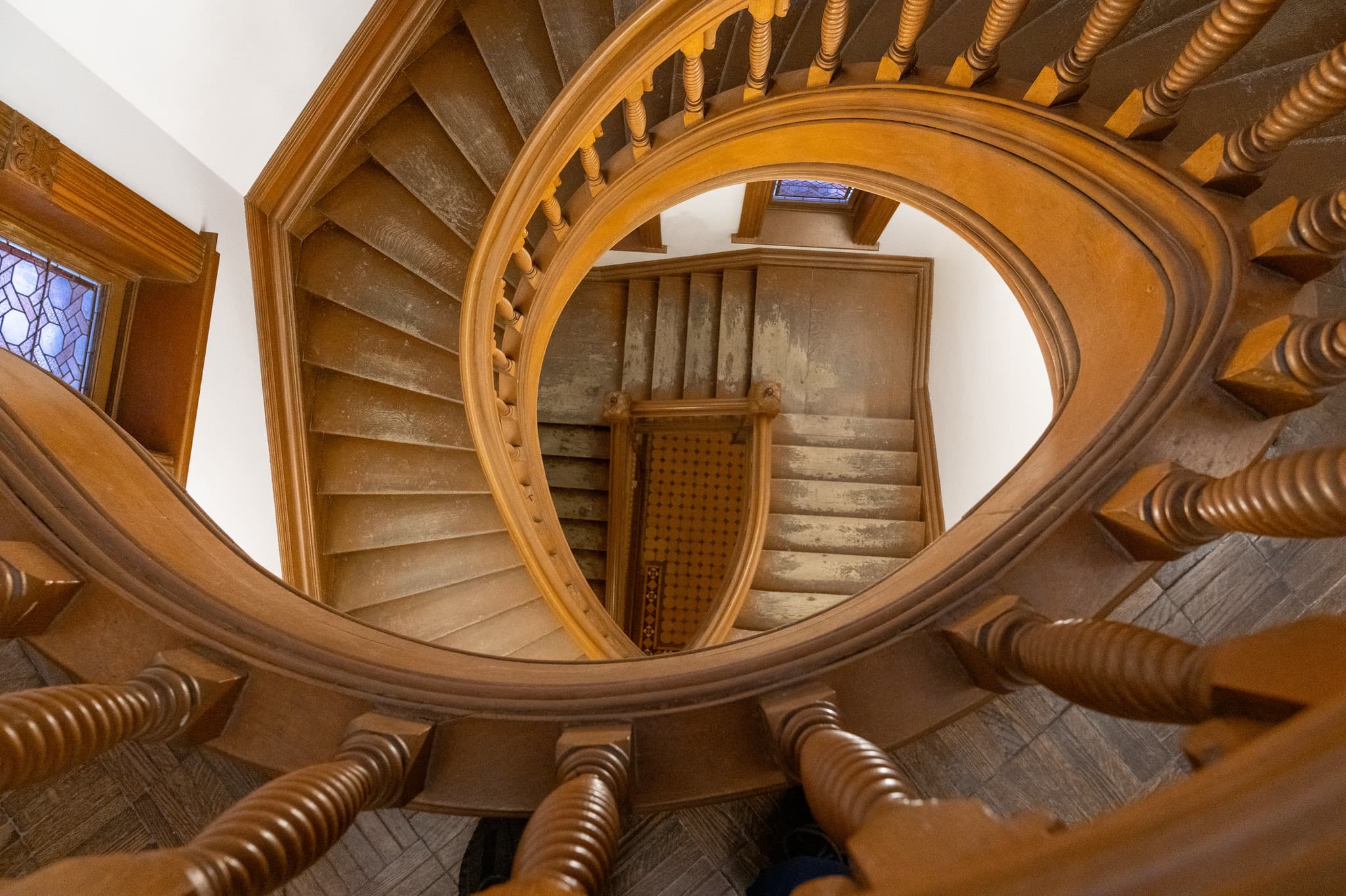 A wooden spiral staircase viewed from above.